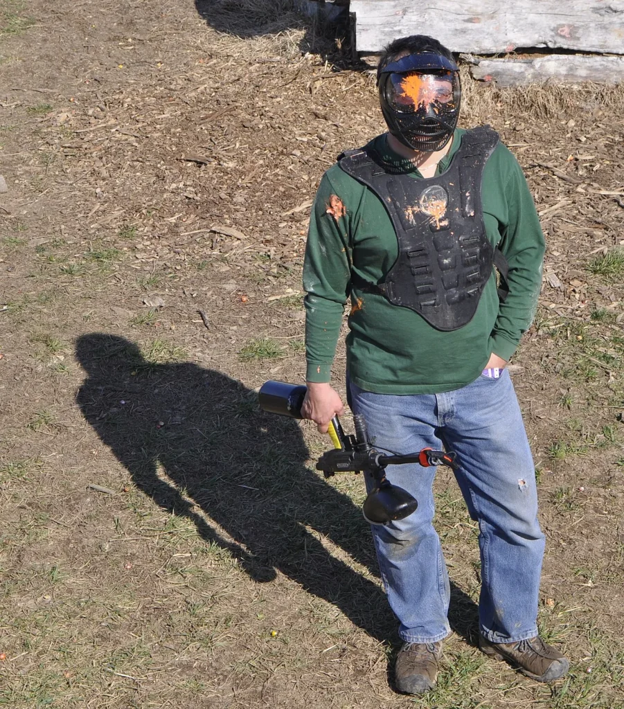 Paintball player wearing a full-face mask on the field